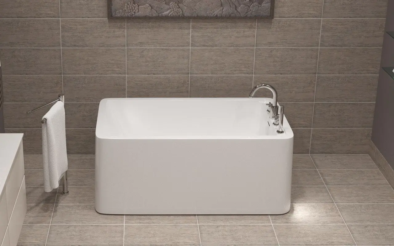Modern square bathtub in a minimalist tiled bathroom