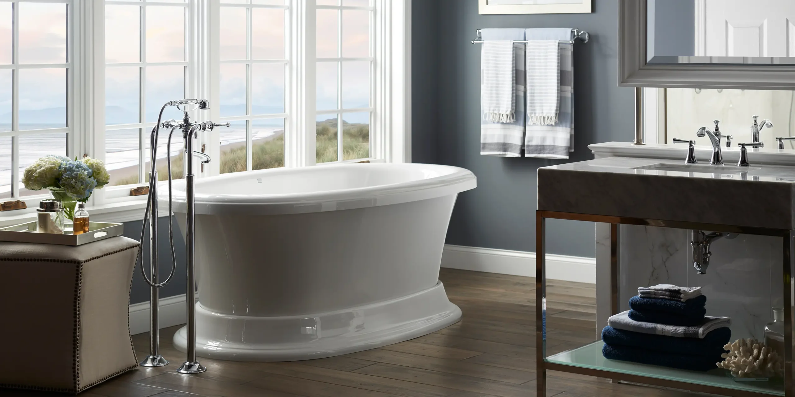 Luxurious freestanding bathtub in a coastal-themed bathroom with ocean view