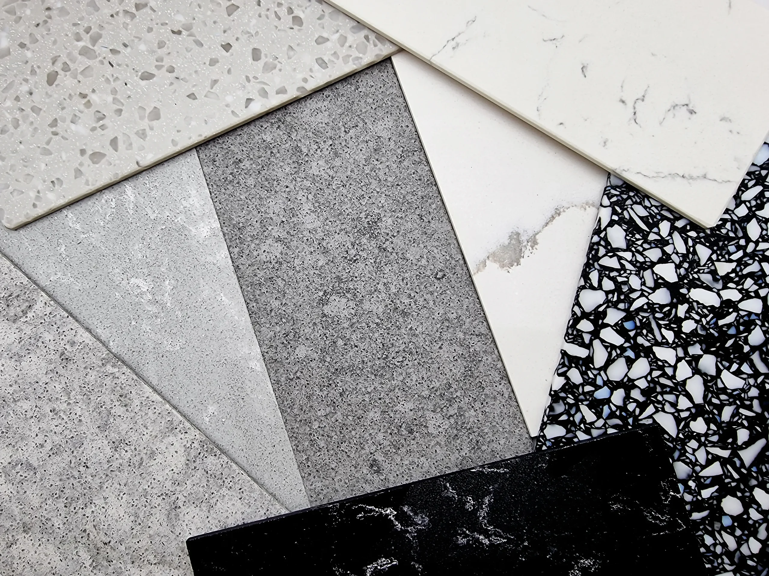 Assorted bathroom flooring tile samples in various colors and textures