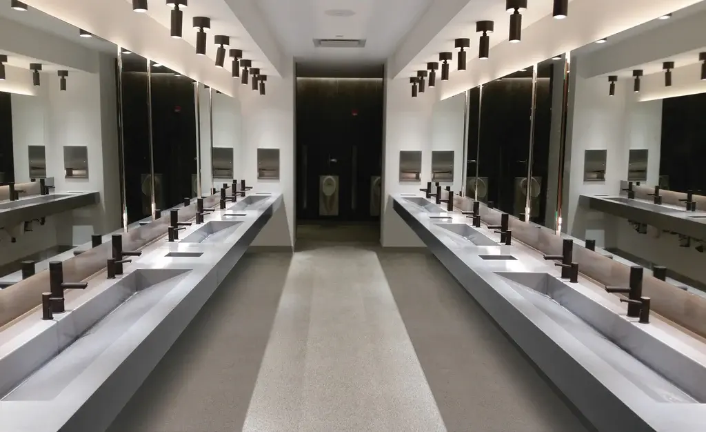 Modern public restroom with dual sink stations and sleek lighting