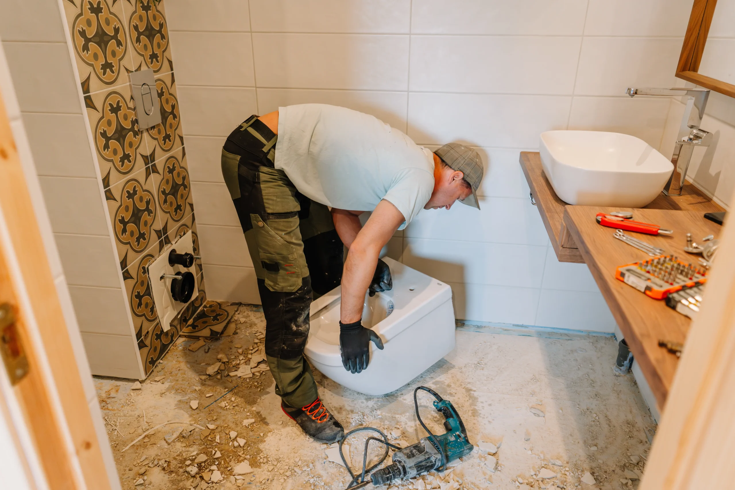 Contractor installing toilet during bathroom renovation