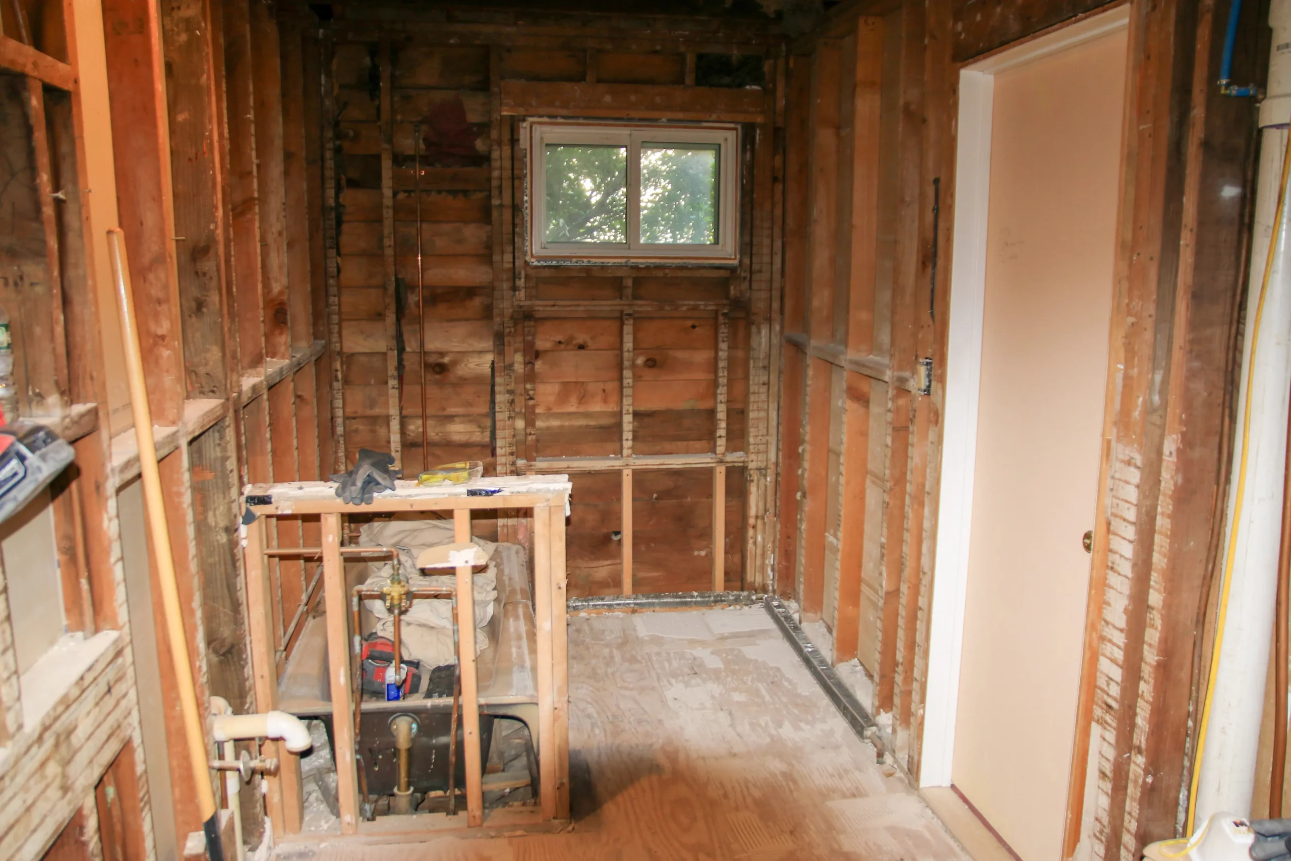 Bathroom stripped to studs during demolition phase of renovation