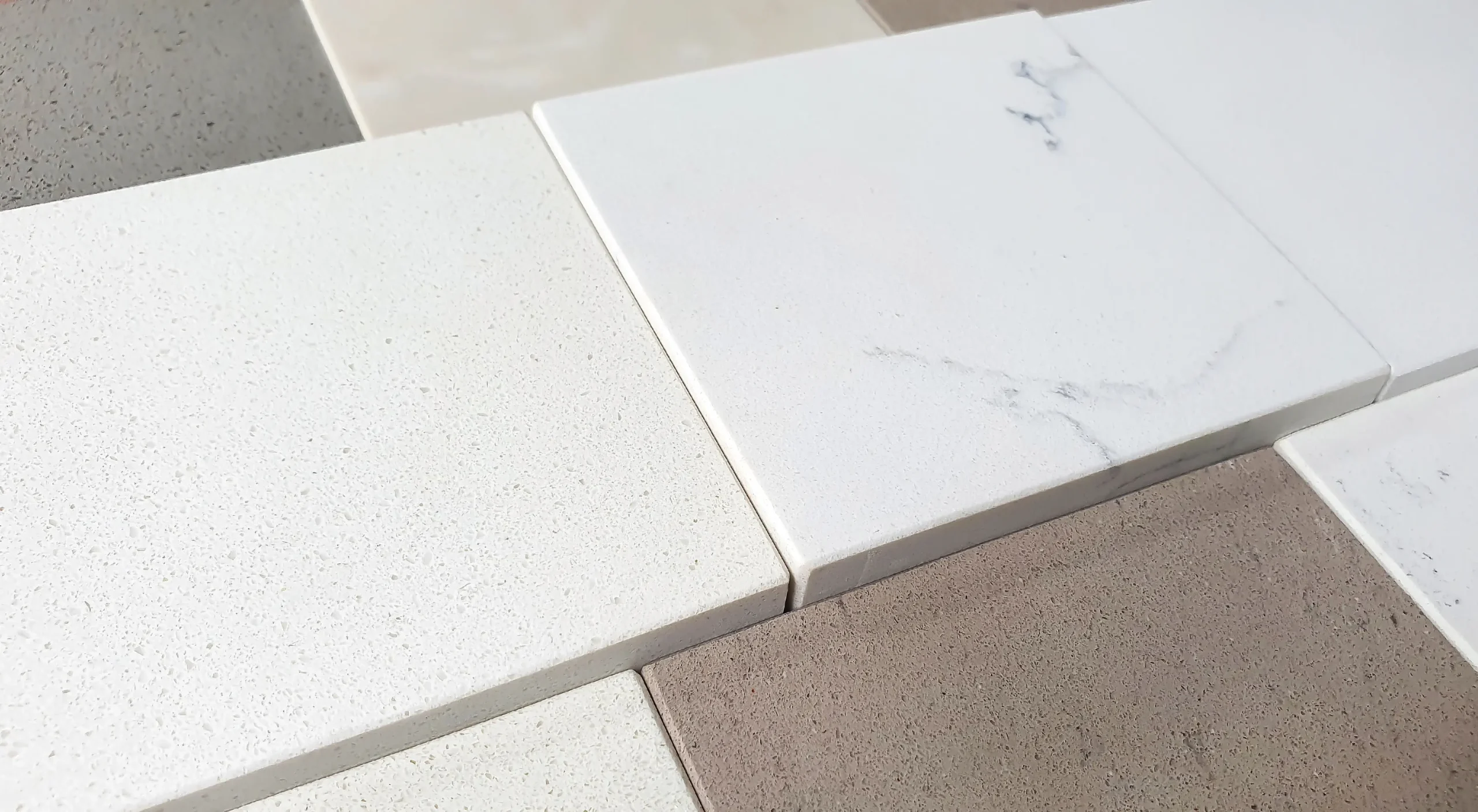 White and beige bathroom tile samples with matte and marble finishes